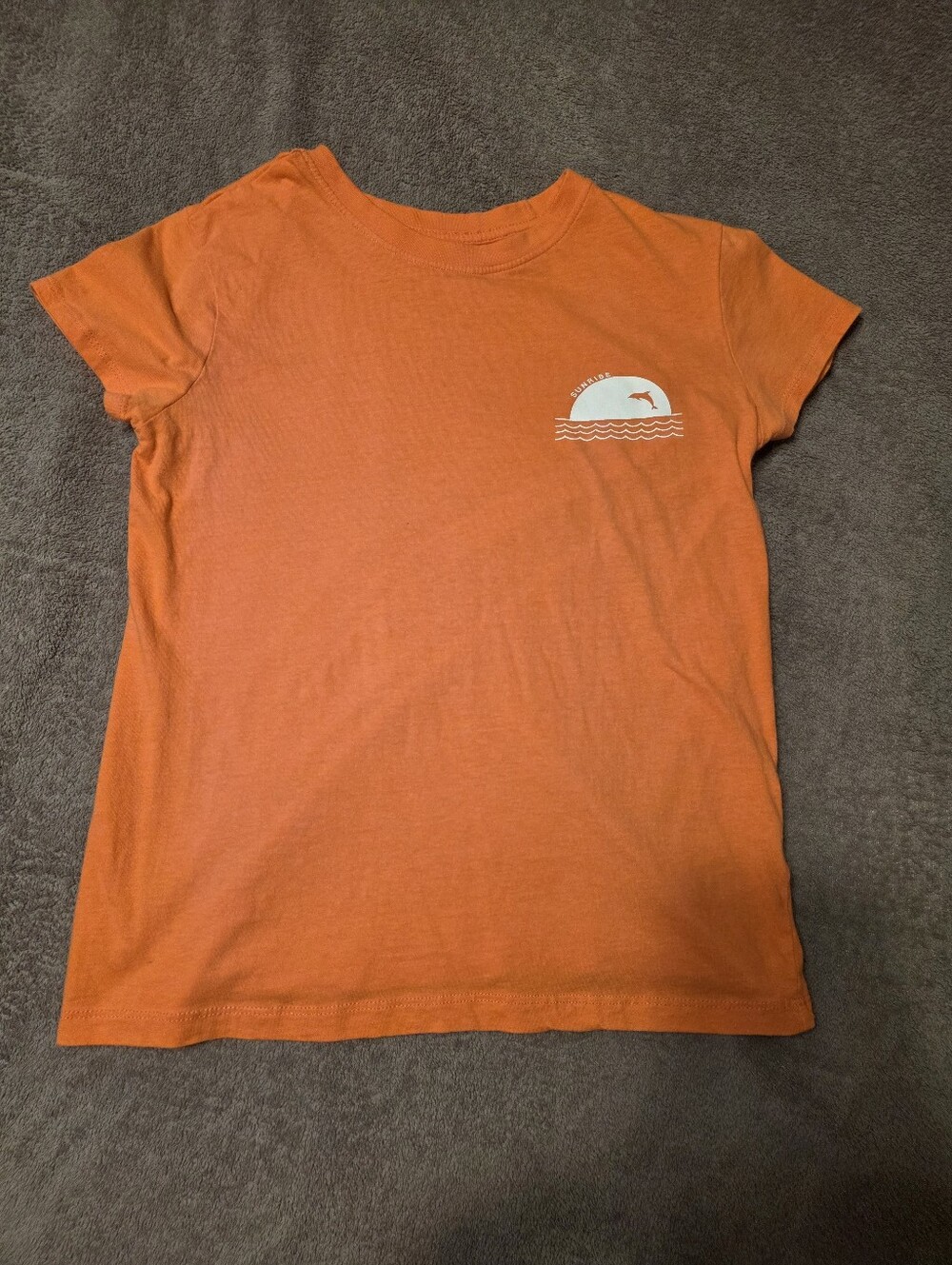 Orange shirt with dolphin design